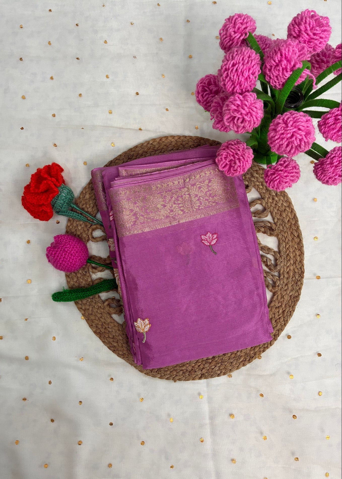 Purple saree with floral decorations on a textured surface