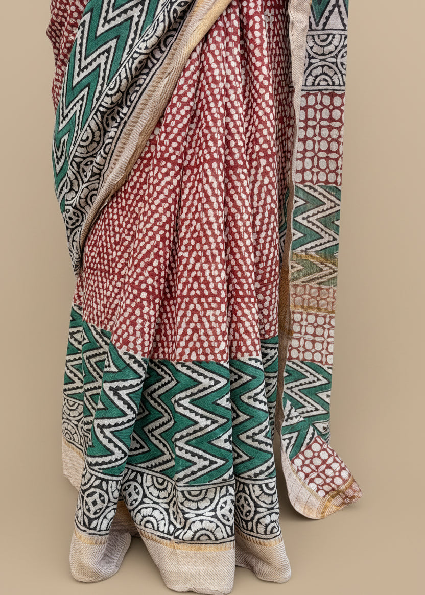 Traditional saree with geometric patterns on a grassy background
