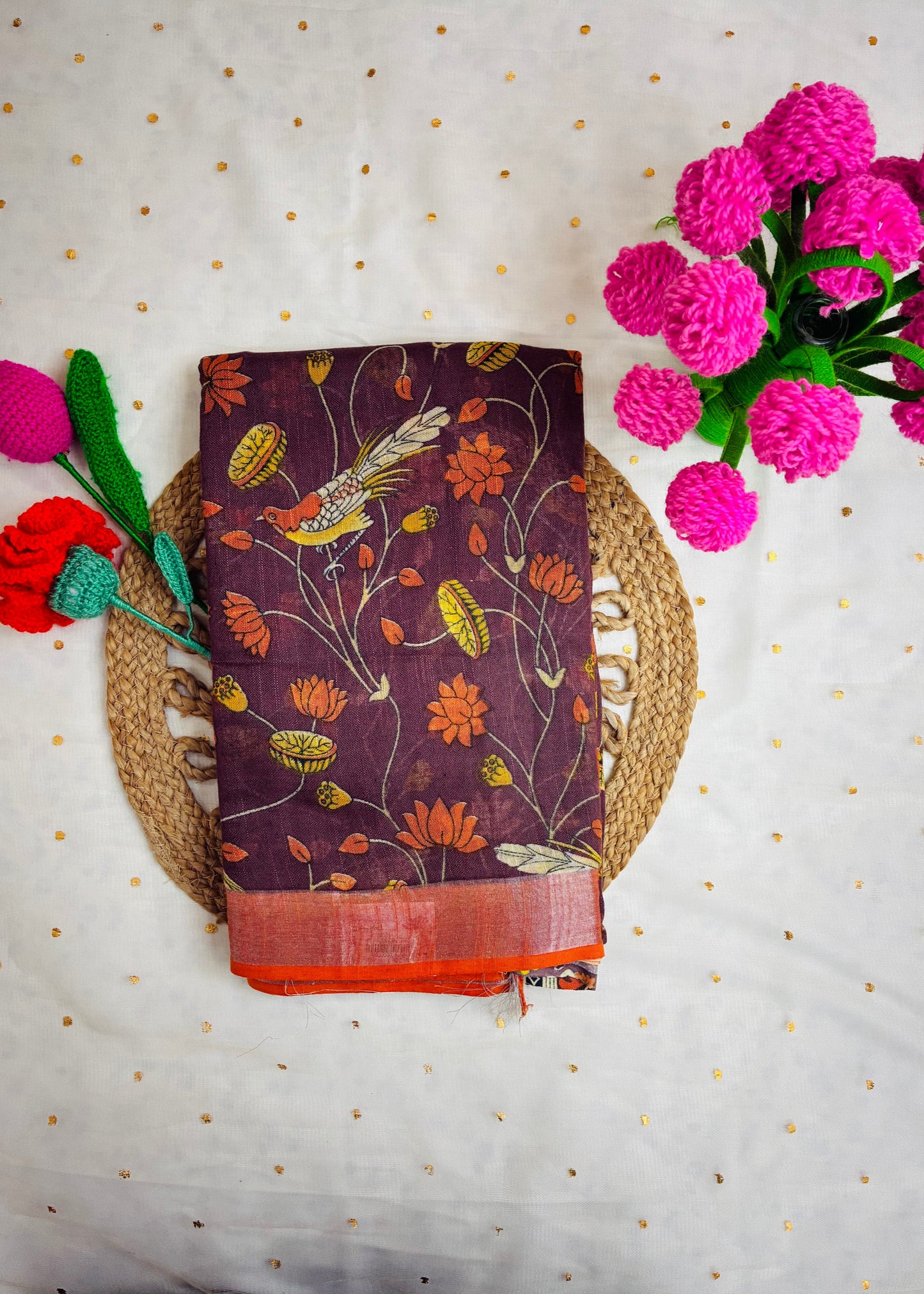 Decorative fabric with floral and bird pattern on a textured surface with flowers.