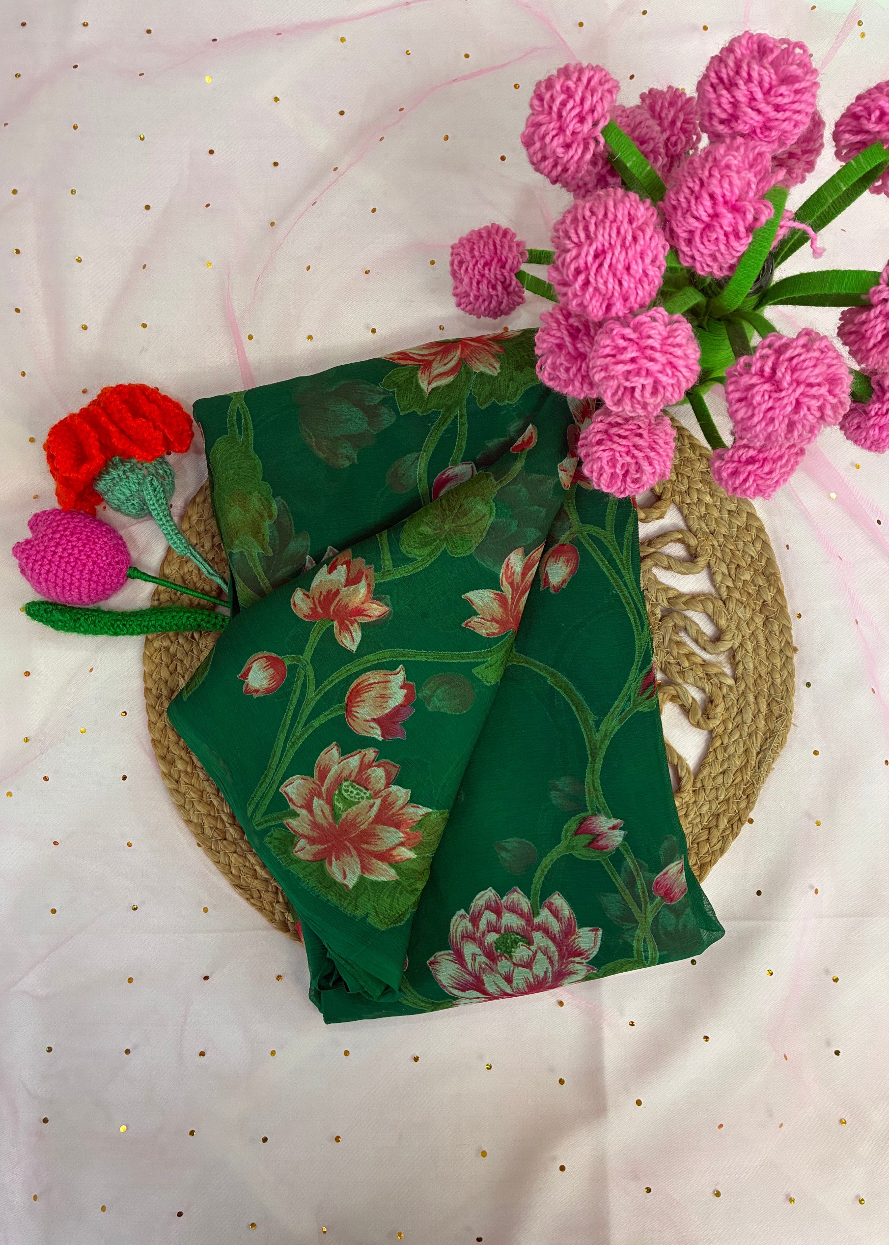 Green floral fabric with pink and red flowers on a white background