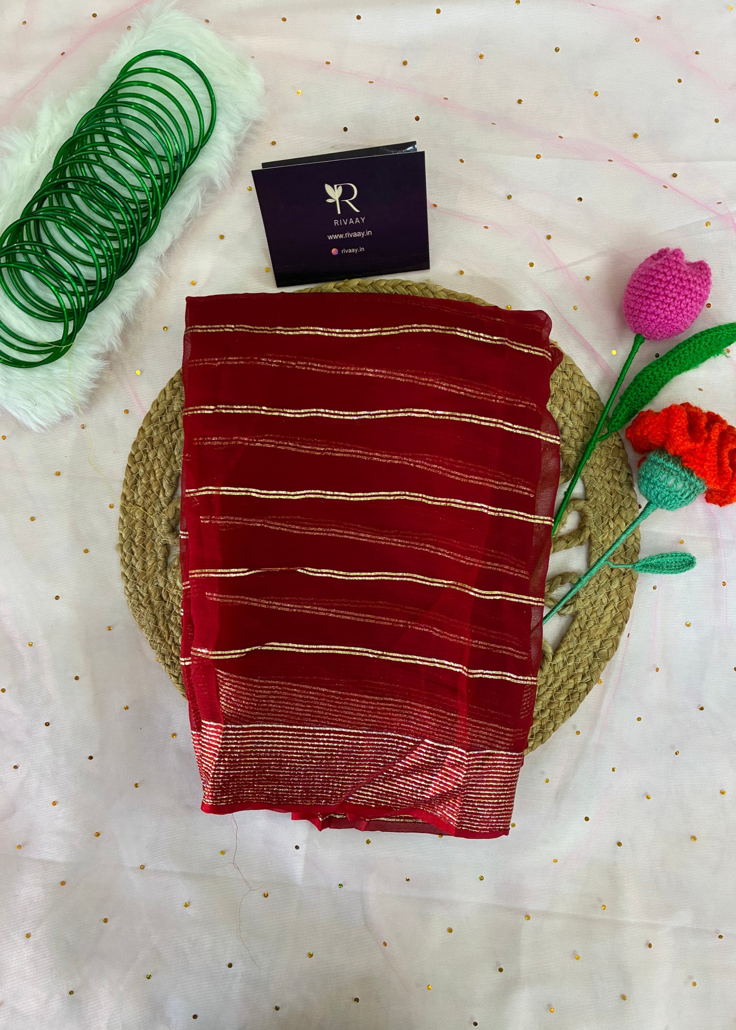 Red fabric with white stripes on a textured surface with decorative elements.