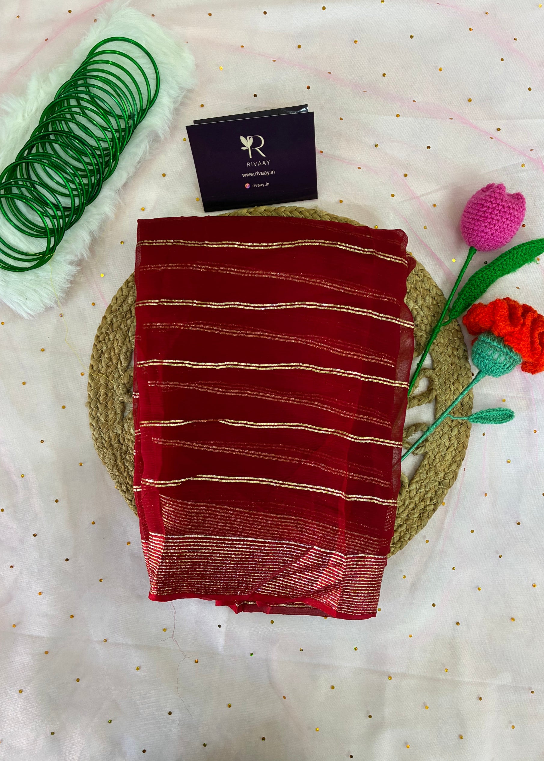 Red fabric with white stripes on a textured surface with decorative elements.