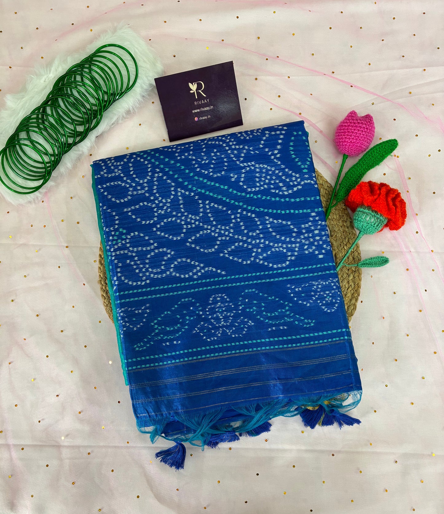 Blue patterned fabric with tassels on a white background