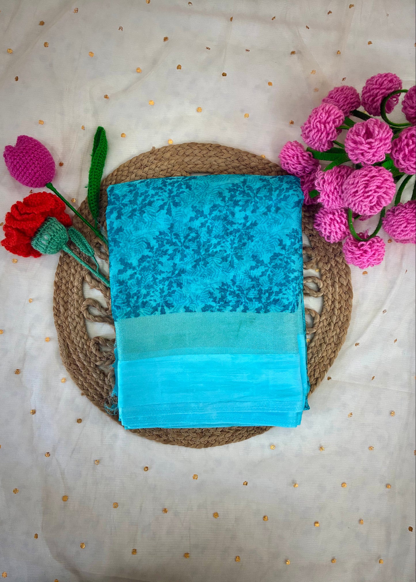 Blue fabric with floral pattern on a textured surface with flowers