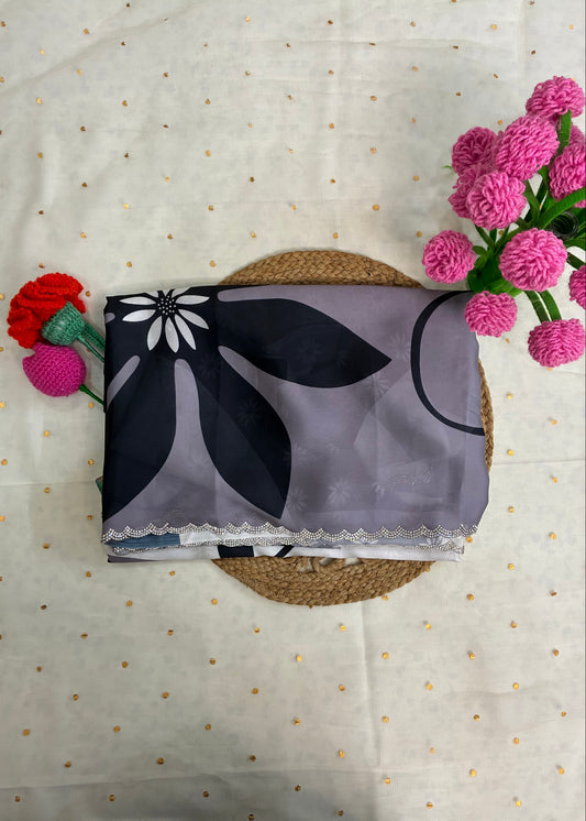 Floral-patterned fabric on a textured surface with pink flowers and a red flower arrangement.